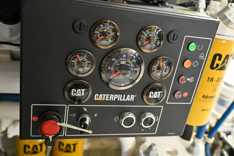 Caraibi Yacht Photos Pics Caterpillar engine control panel on 2013 Hatteras GT63 yacht, featuring gauges and indicators.
