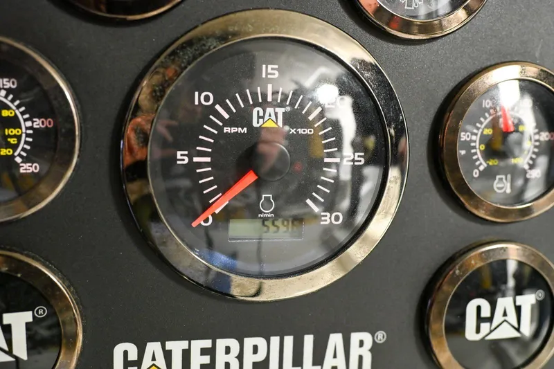 Caraibi Yacht Photos Pics Caterpillar engine gauges on a 2013 Hatteras GT63 yacht dashboard.