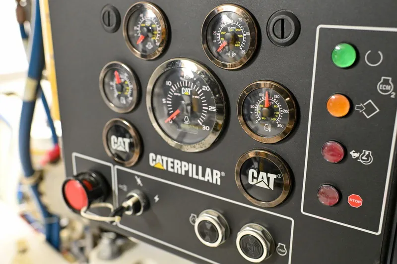 Caraibi Yacht Photos Pics Control panel of a 2013 Hatteras GT63 yacht with Caterpillar gauges and buttons.