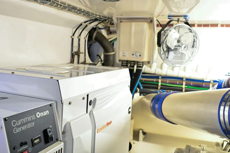 Caraibi Yacht Photos Pics Engine room of 2013 Hatteras GT63 yacht with Cummins Onan generator and ventilation system.