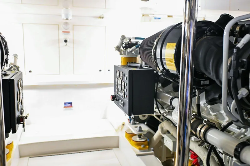 Caraibi Yacht Photos Pics Engine room of a 2013 Hatteras GT63 yacht, showcasing mechanical components and systems.