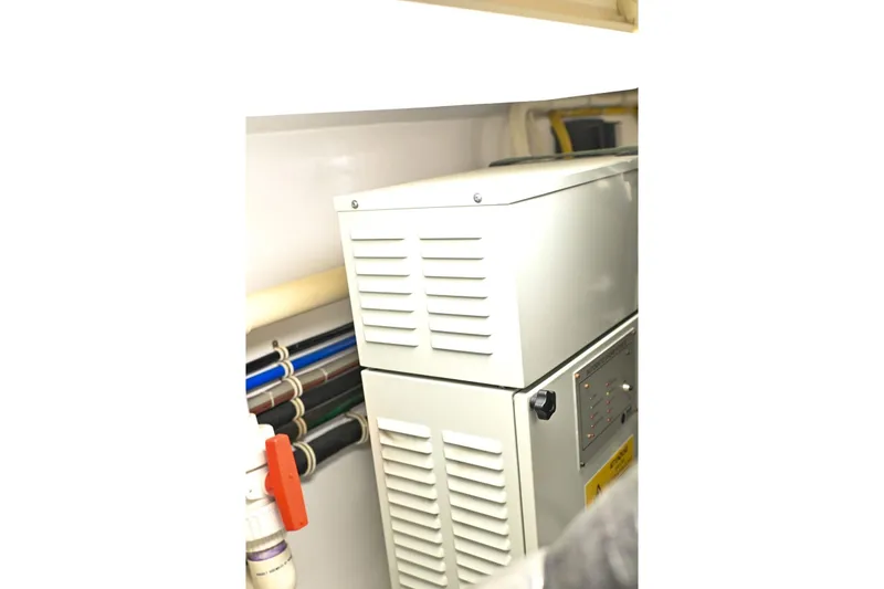 Caraibi Yacht Photos Pics Engine room of 2013 Hatteras GT63 yacht with mechanical equipment and piping.