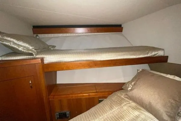 Caraibi Yacht Photos Pics Interior cabin of 2013 Hatteras GT63 yacht with wooden bunk beds.