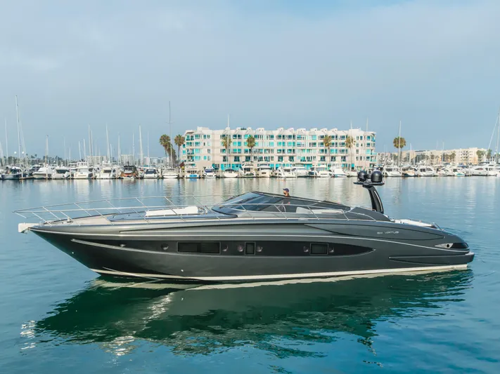 Pergola Yacht Photos Pics 2016 Riva 63 Virtus yacht on calm water near marina and modern buildings.