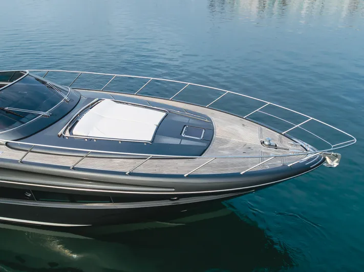Pergola Yacht Photos Pics 2016 Riva 63 Virtus yacht on calm water, showcasing sleek design and luxury features.