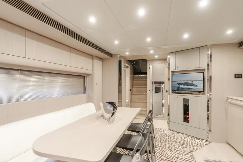 Pergola Yacht Photos Pics Luxurious interior of 2016 Riva 63 Virtus yacht with modern dining area and TV.