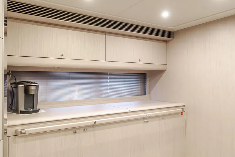 Pergola Yacht Photos Pics Modern kitchen area in 2016 Riva 63 Virtus yacht with sleek cabinetry and coffee maker.