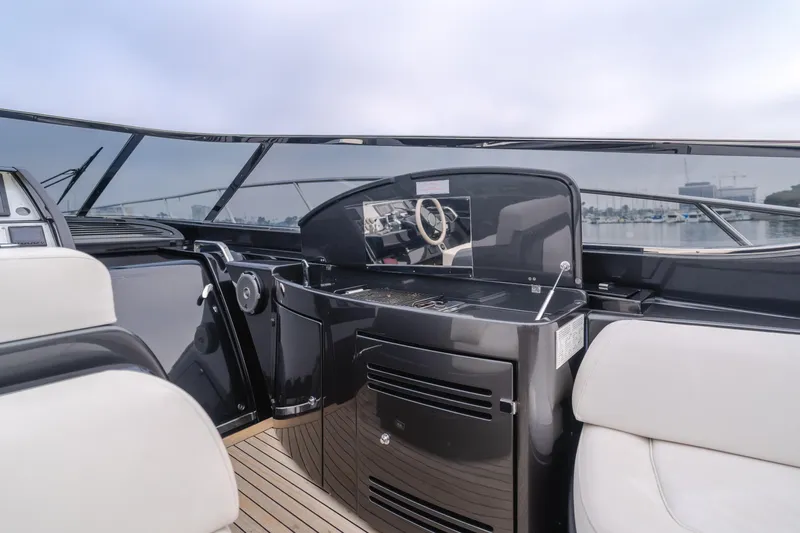 Pergola Yacht Photos Pics Interior of 2016 Riva 63 Virtus yacht, featuring sleek black console and white seating.