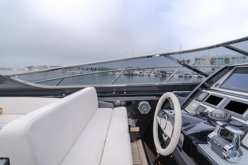 Pergola Yacht Photos Pics Interior view of 2016 Riva 63 Virtus yacht cockpit with steering wheel and controls.