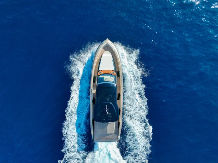  Yacht Photos Pics Aerial view of 2020 Invictus TT460 yacht cruising on blue ocean waters.