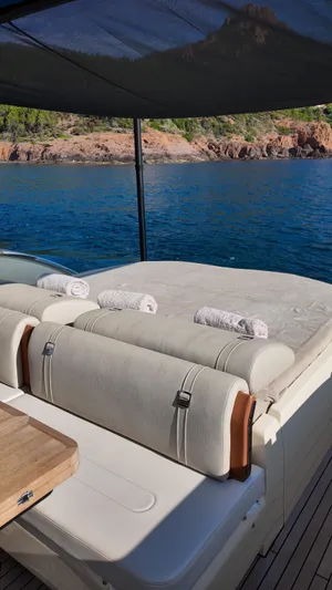  Yacht Photos Pics Luxurious Invictus TT460 yacht deck with sunbathing area, towels, and scenic ocean view.