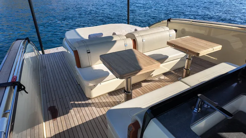  Yacht Photos Pics Luxurious Invictus TT460 yacht deck with seating and tables, 2020 model, on serene blue water.
