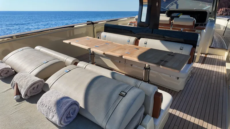  Yacht Photos Pics Luxurious 2020 Invictus TT460 yacht interior with seating, wooden table, and ocean view.