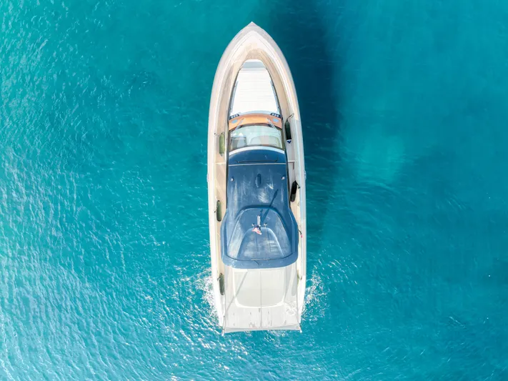  Yacht Photos Pics Aerial view of 2020 Invictus TT460 yacht on clear blue water.
