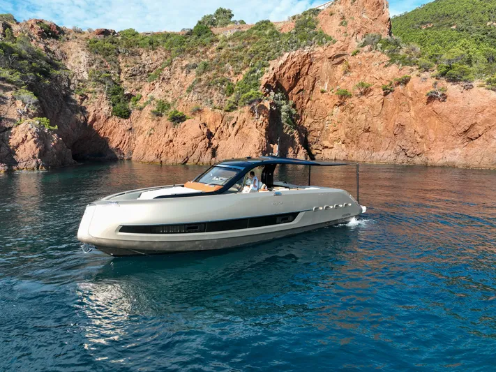  Yacht Photos Pics 2020 Invictus TT460 yacht cruising near rocky coastline.