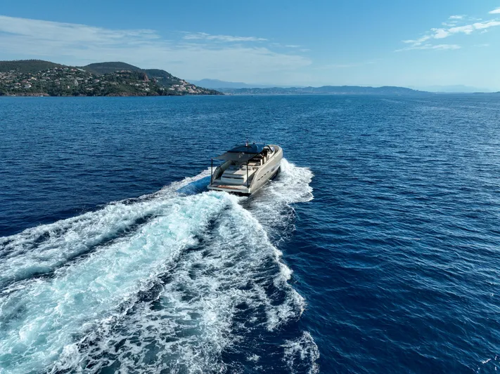  Yacht Photos Pics Invictus TT460 yacht cruising on open sea, 2020 model, with scenic coastal backdrop.