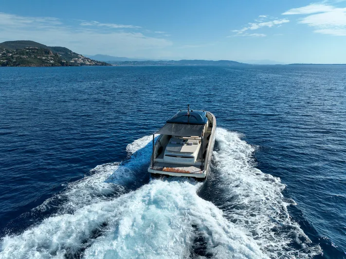  Yacht Photos Pics Invictus TT460 yacht cruising on open sea, 2020 model, with scenic coastal backdrop.