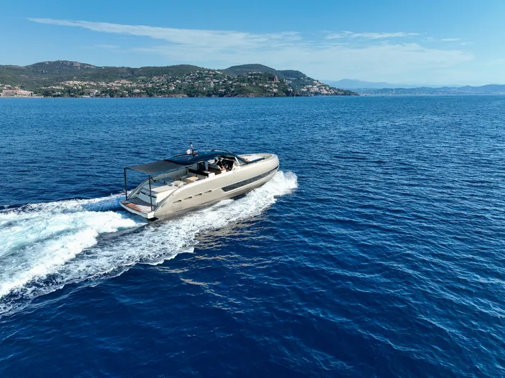  Yacht Photos Pics Invictus TT460 yacht cruising on blue ocean, 2020 model, scenic coastal backdrop.