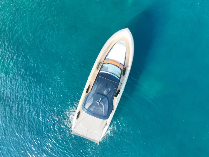  Yacht Photos Pics Aerial view of 2020 Invictus TT460 yacht on clear blue water.