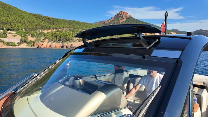  Yacht Photos Pics 2020 Invictus TT460 yacht cruising on scenic blue waters with lush green hills.