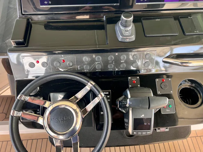  Yacht Photos Pics 2024 Pardo Yachts P38 helm with steering wheel, controls, and navigation instruments.