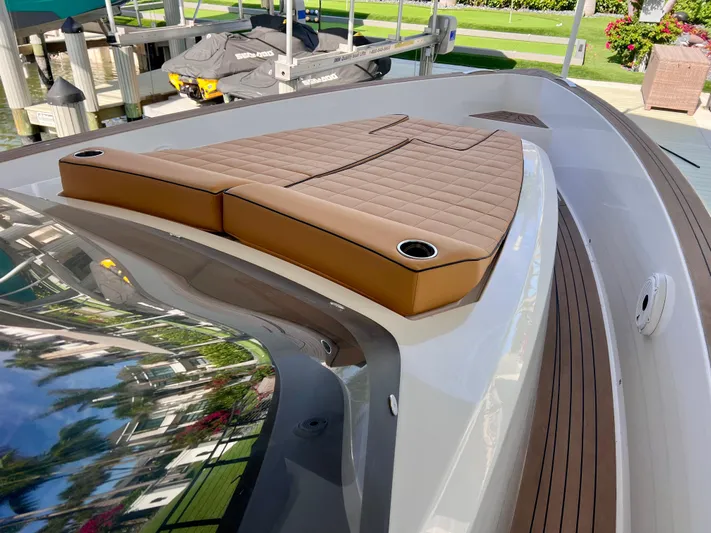  Yacht Photos Pics 2024 Pardo Yachts P38 with brown cushioned deck, docked near greenery.