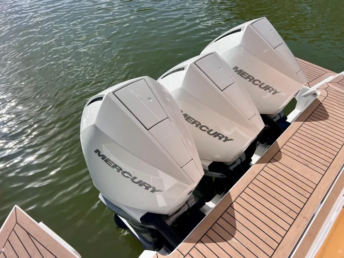  Yacht Photos Pics Triple Mercury outboard engines on 2024 Pardo Yachts P38, docked on wooden deck.