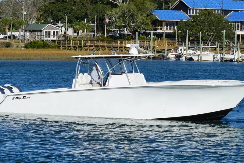  Yacht Photos Pics 2024 SeaHunter 39 Tournament boat cruising on a calm waterfront.