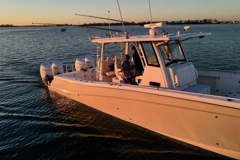  Yacht Photos Pics 2022 World Cat 400 CC-X boat cruising at sunset with multiple outboard engines.