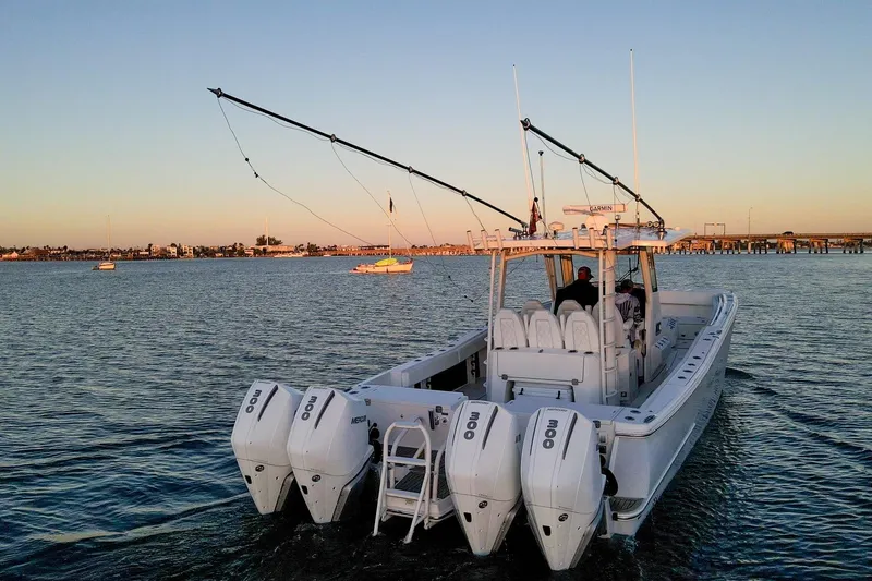  Yacht Photos Pics 2022 World Cat 400 CC-X boat cruising on calm waters at sunset.