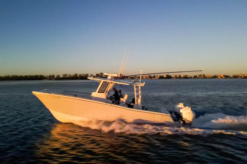  Yacht Photos Pics 2022 World Cat 400 CC-X cruising on water at sunset, showcasing sleek design and performance.