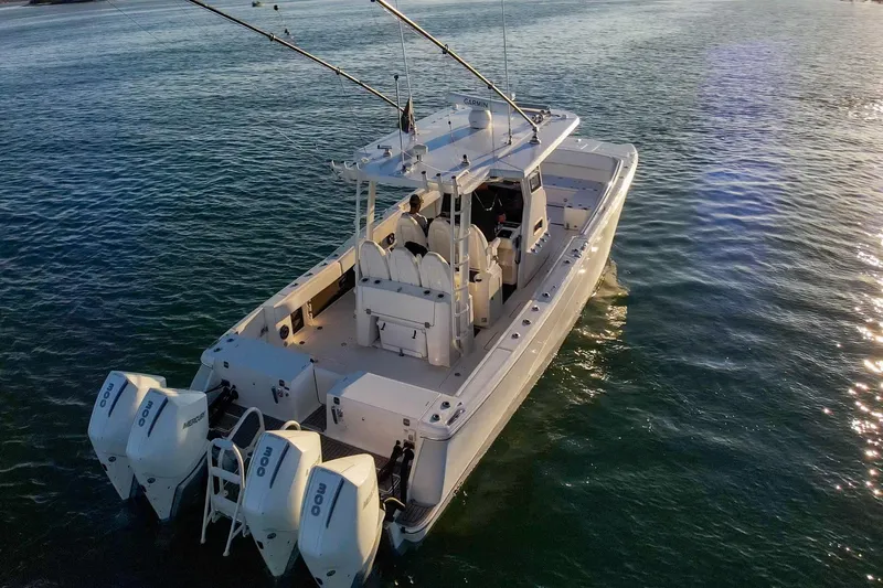  Yacht Photos Pics 2022 World Cat 400 CC-X boat on calm water, featuring dual outboard engines.