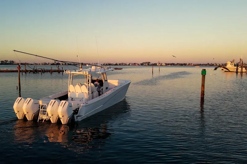  Yacht Photos Pics 2022 World Cat 400 CC-X boat cruising at sunset on calm waters.