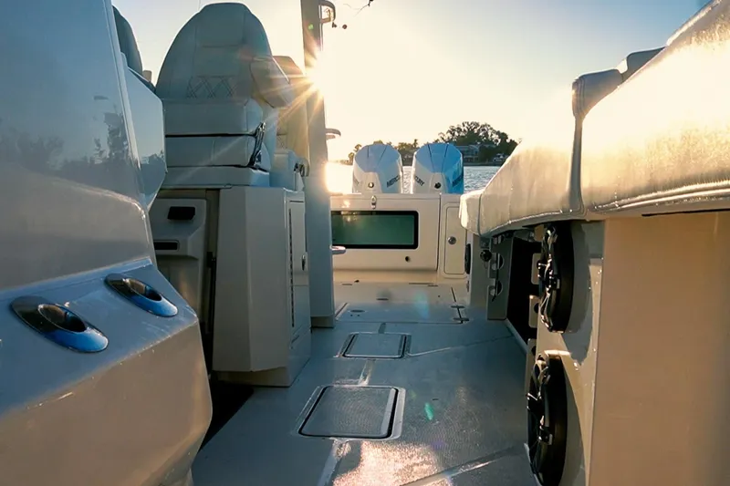  Yacht Photos Pics 2022 World Cat 400 CC-X boat interior with seating and dual engines at sunset.
