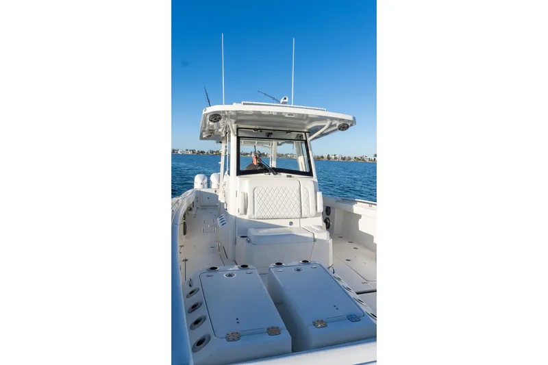  Yacht Photos Pics 2022 World Cat 400 CC-X boat on water, showcasing spacious deck and helm.