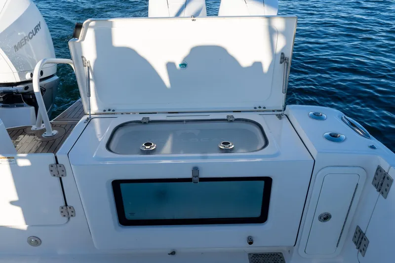  Yacht Photos Pics 2022 World Cat 400 CC-X boat with open storage compartment on deck.