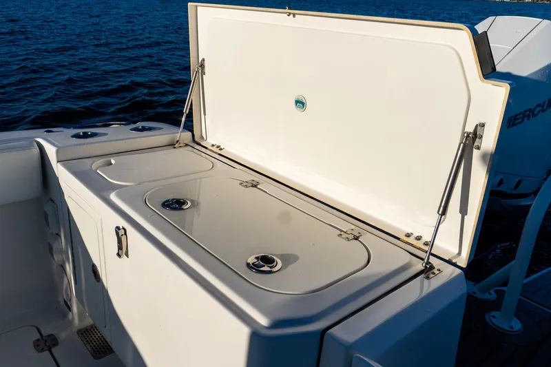  Yacht Photos Pics Open storage compartment on 2022 World Cat 400 CC-X boat, with ocean background.
