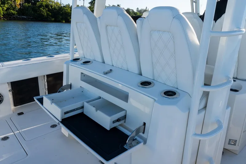  Yacht Photos Pics 2022 World Cat 400 CC-X boat with open storage drawers and white seating.