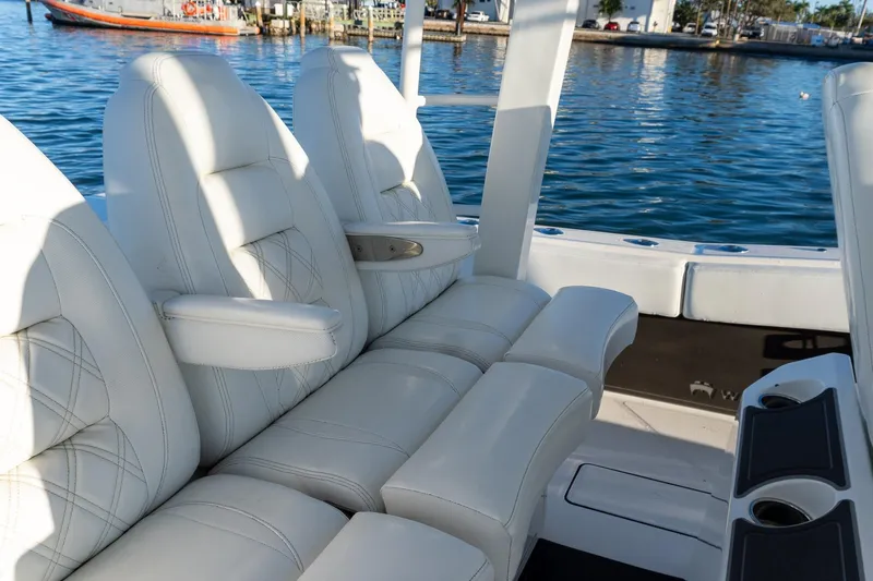  Yacht Photos Pics Luxurious seating on 2022 World Cat 400 CC-X boat, docked by the water.