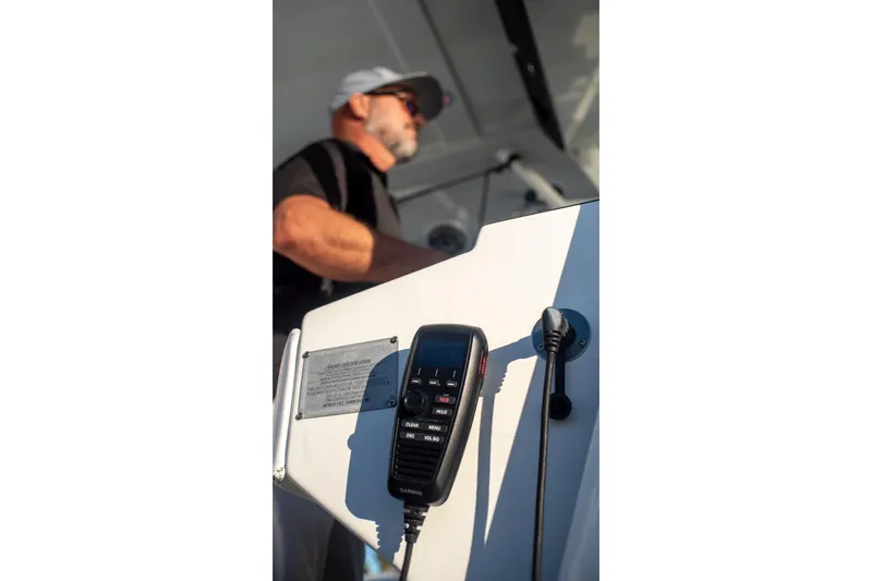  Yacht Photos Pics Man operating 2022 World Cat 400 CC-X boat with radio equipment.