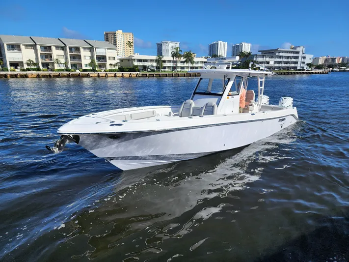  Yacht Photos Pics 2019 Everglades 365 boat cruising in a coastal city marina.