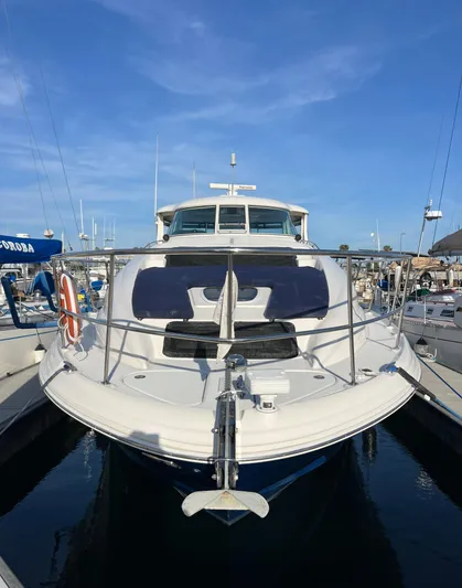 Reflections Yacht Photos Pics 2005 Sea Ray 390 Motor Yacht docked in marina under clear blue sky.