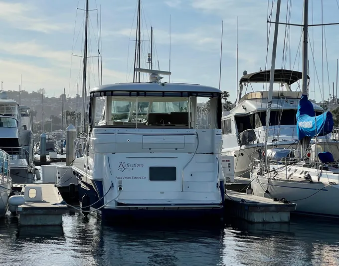 Reflections Yacht Photos Pics 2005 Sea Ray 390 Motor Yacht docked at marina, surrounded by other boats.