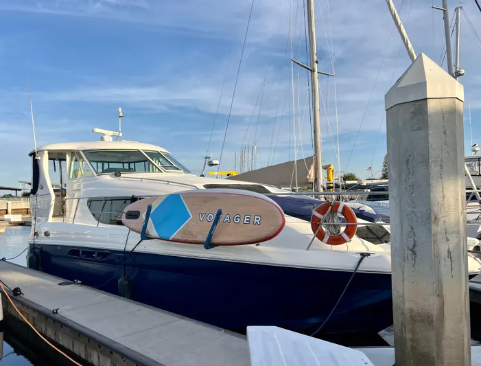 Reflections Yacht Photos Pics 2005 Sea Ray 390 Motor Yacht docked with a paddleboard and lifebuoy.
