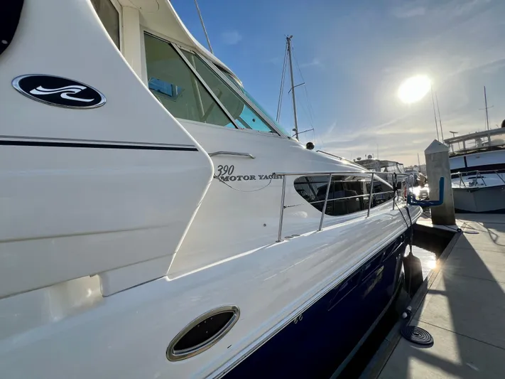 Reflections Yacht Photos Pics 2005 Sea Ray 390 Motor Yacht docked under bright sunlight.
