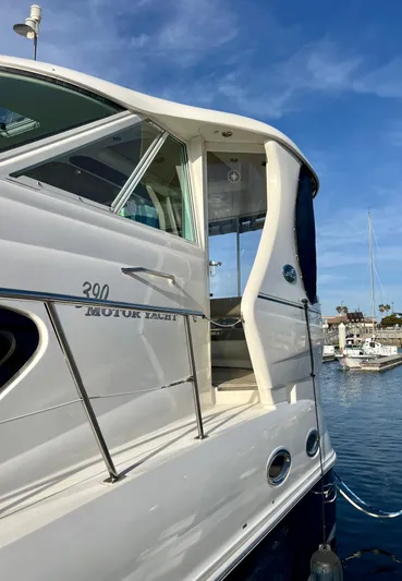 Reflections Yacht Photos Pics 2005 Sea Ray 390 Motor Yacht docked at marina under clear blue sky.