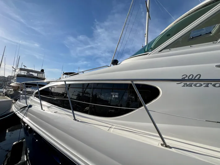 Reflections Yacht Photos Pics 2005 Sea Ray 390 Motor Yacht docked under clear blue sky.
