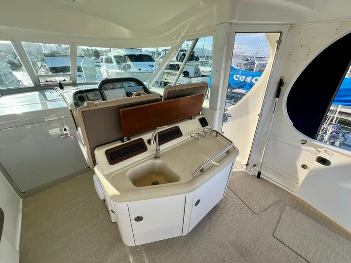 Reflections Yacht Photos Pics 2005 Sea Ray 390 Motor Yacht helm with sink and seating area.