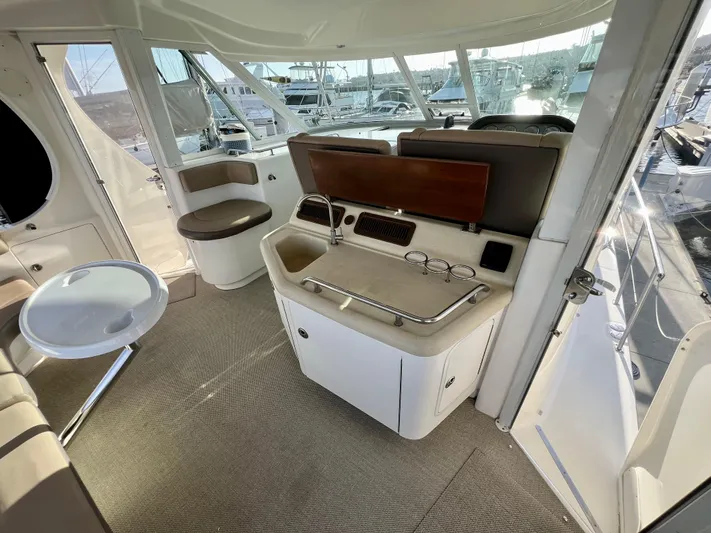 Reflections Yacht Photos Pics 2005 Sea Ray 390 Motor Yacht interior with helm, seating, and panoramic windows.