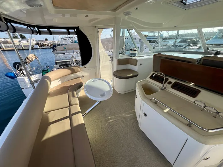Reflections Yacht Photos Pics 2005 Sea Ray 390 Motor Yacht interior with seating and kitchenette, docked at marina.
